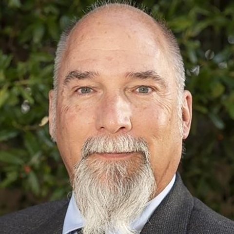 headshot of man with graying beard